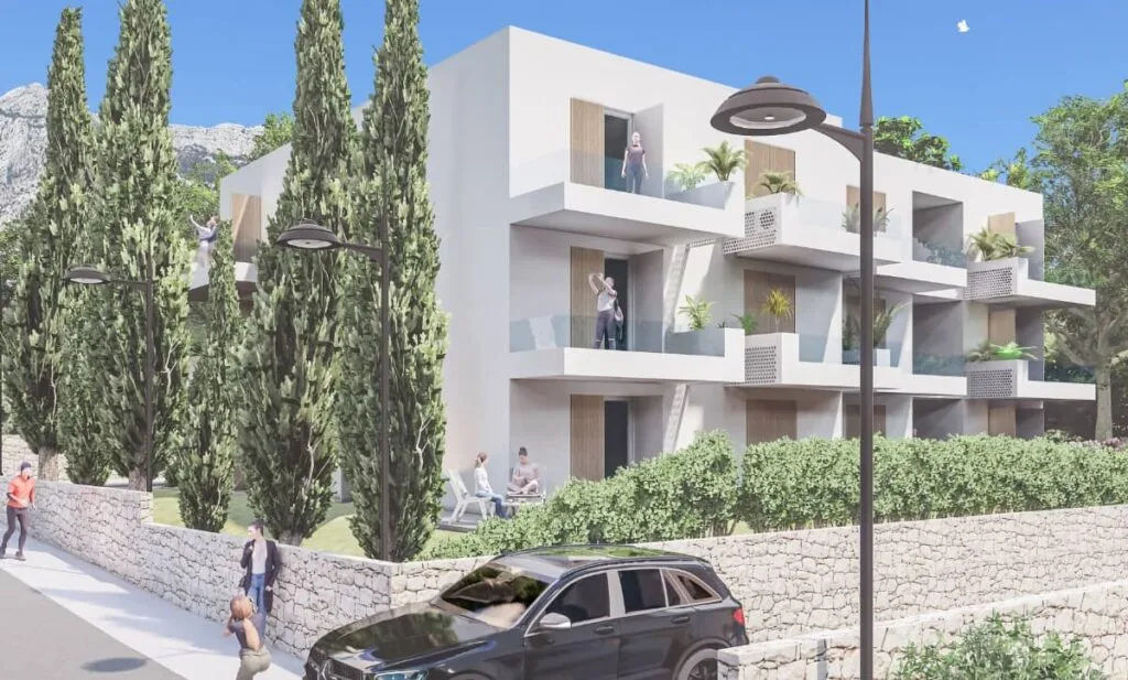 Street-level view of a two-story residential building with balconies, designed by Studio Hatch in Orebić, Croatia.