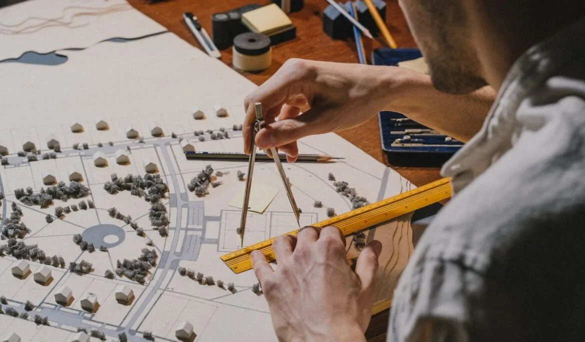 Architect working on a detailed product design and planning model using a compass and ruler, showcasing precision and craftsmanship