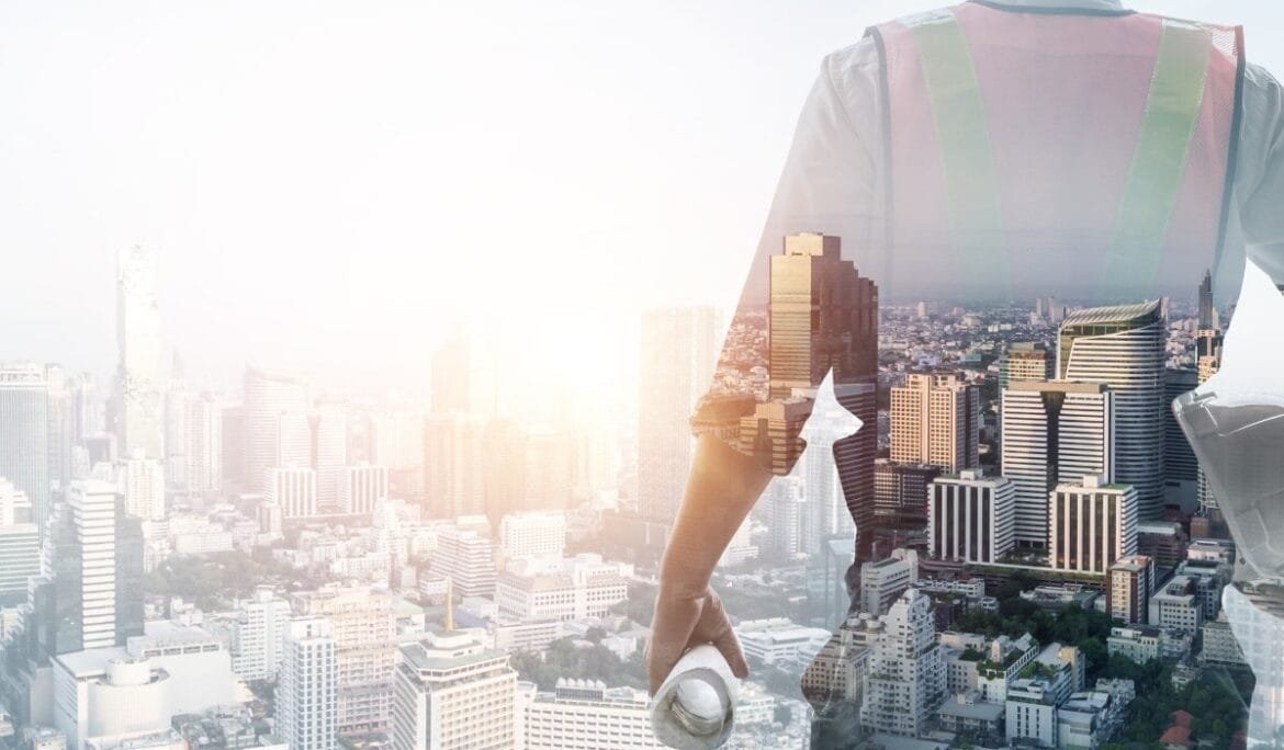 A project manager overlooking a modern city skyline, symbolizing coordination of construction, architectural planning, and project management services.