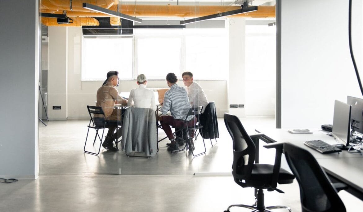 Studio Hatch team discussing architectural consulting services and project planning in modern office setting.