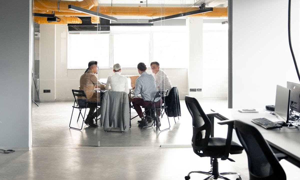 Studio Hatch team discussing architectural consulting services and project planning in modern office setting.